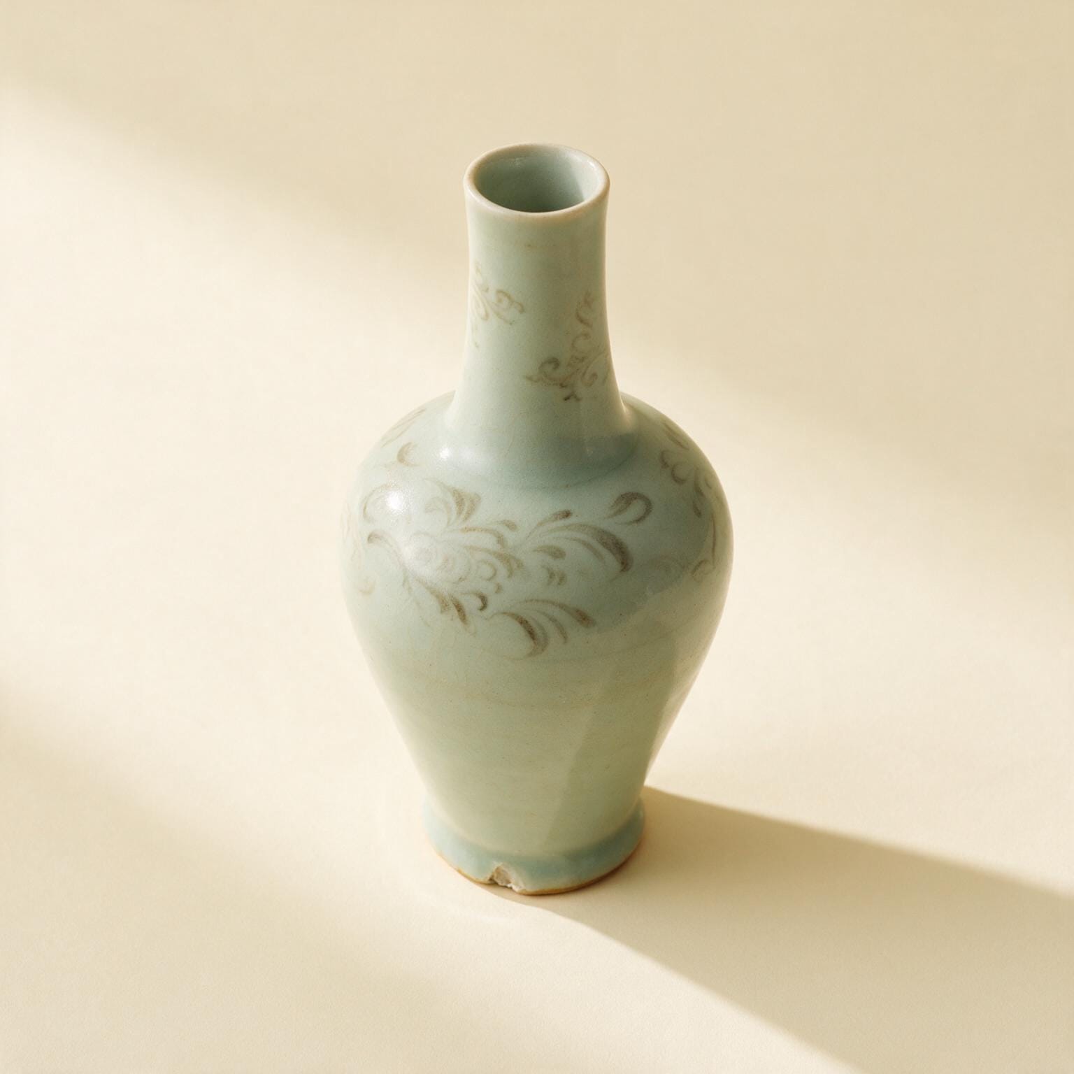 Ostasiatische Porzellanvase mit blassgrüner Glasur, schlankem Hals und kleiner Absplitterung am Fuß